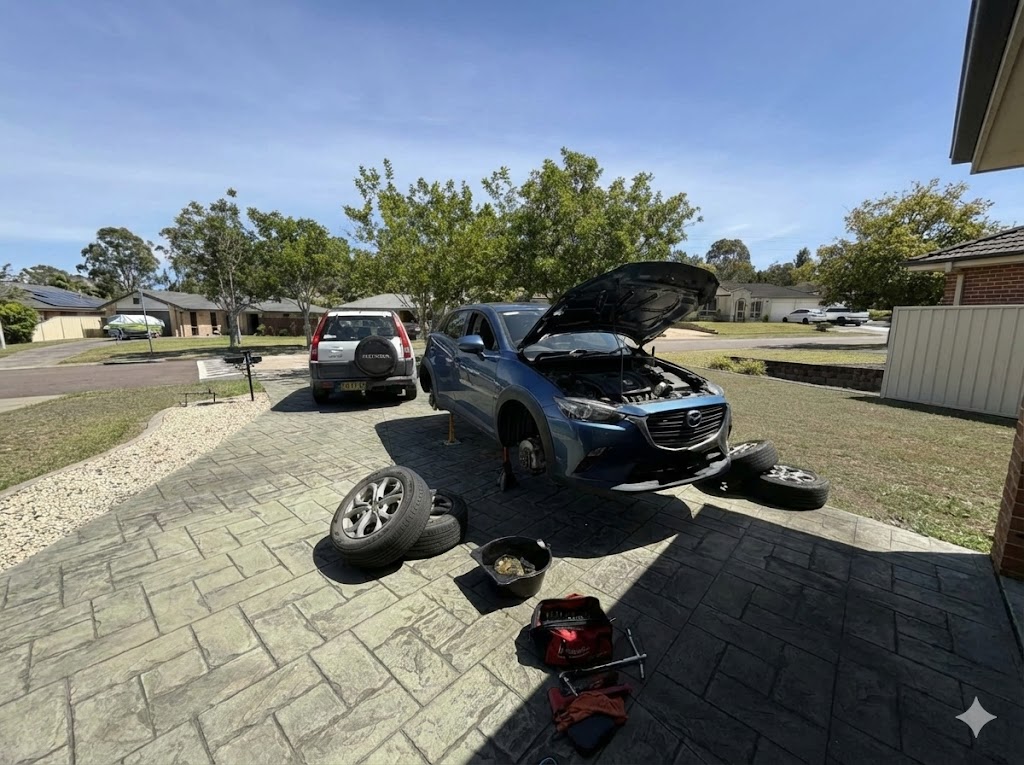 Mobile mechanic servicing a car at a customer's home on the Central Coast NSW, available 7 days a week